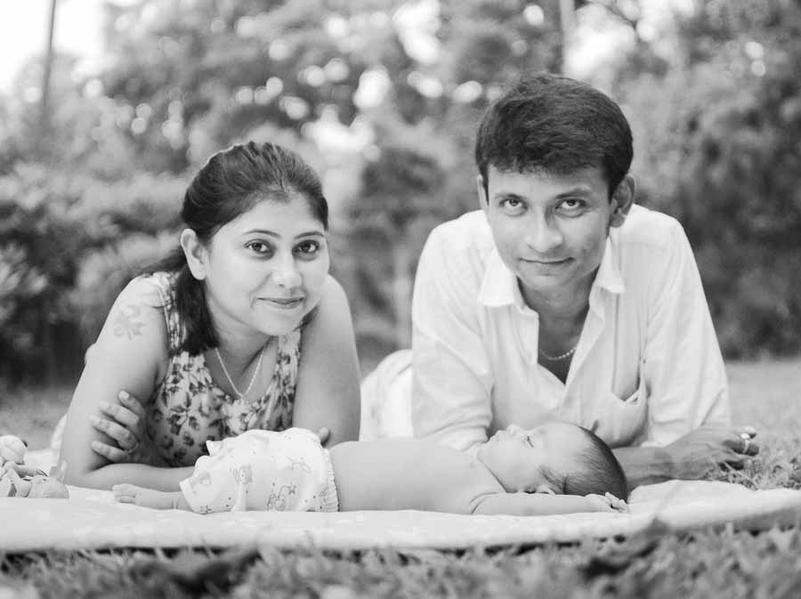black & white outdoor photoshoot of newborn baby with family