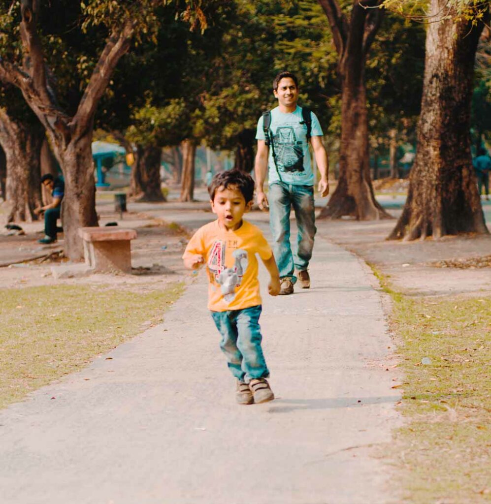 three years kid running in the park