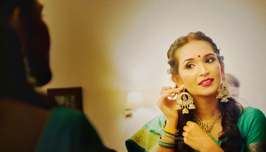 indian bride earrings later in front of the mirror