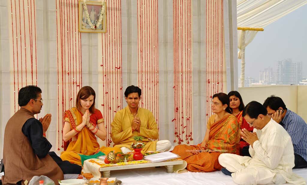 The day before wedding, the Italian bride & Indian groom are worshiping with family, morning Puja