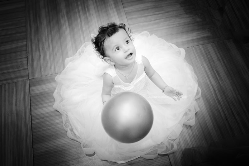 Cute little baby girl playing with balloon on1st birthday