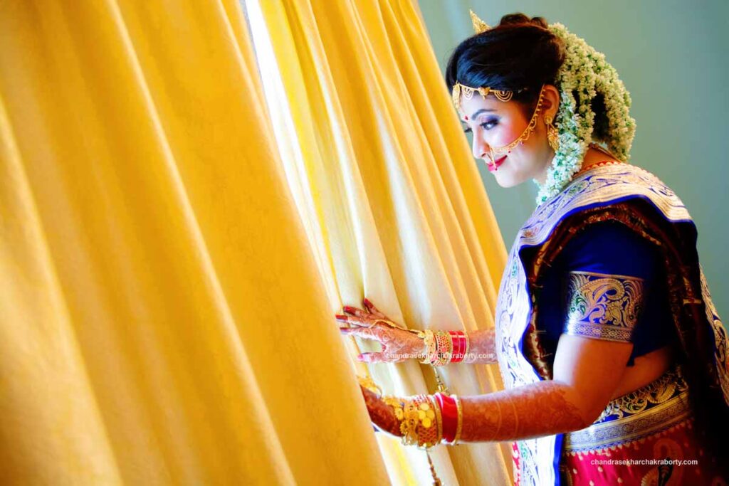 Before wedding a Bengali muslim bride standing in front of the window