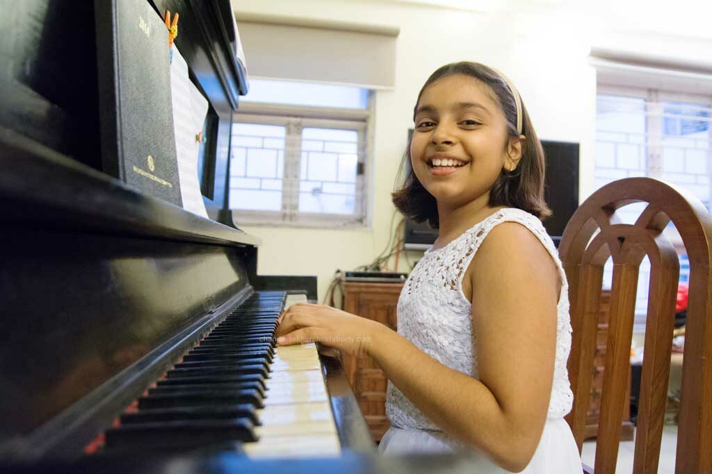 a girl playing piano on her birthday