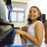 a girl playing piano on her birthday