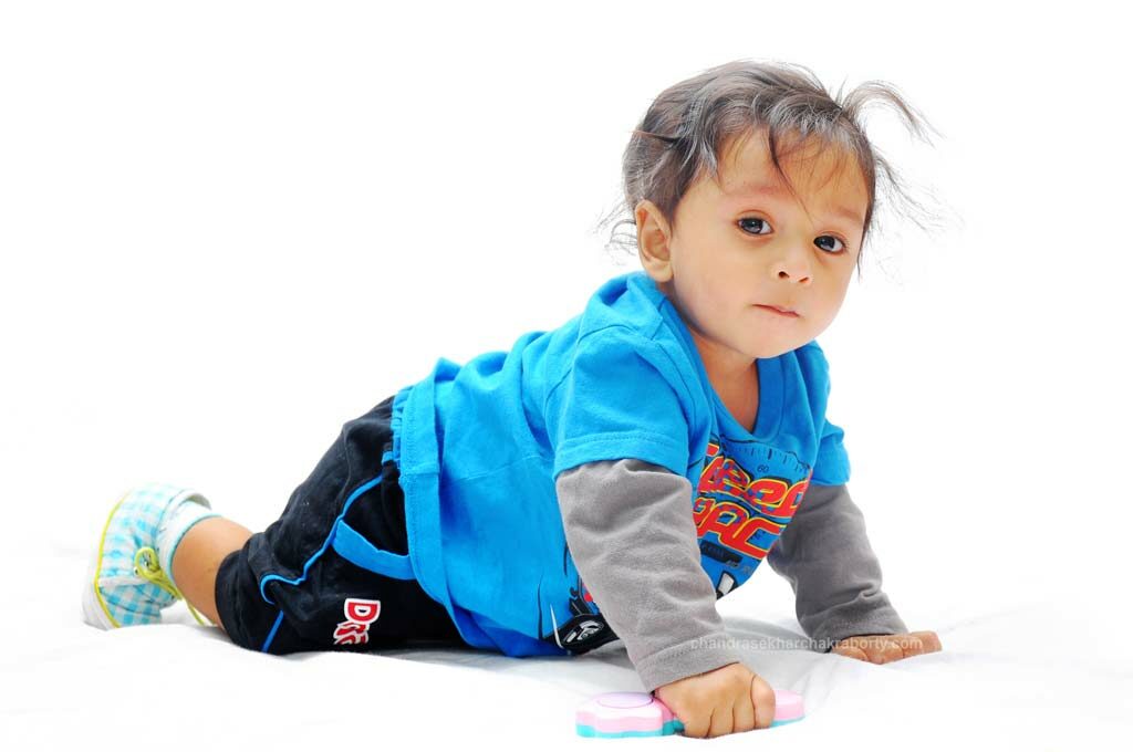 Indoor portrait on white studio background of one year baby